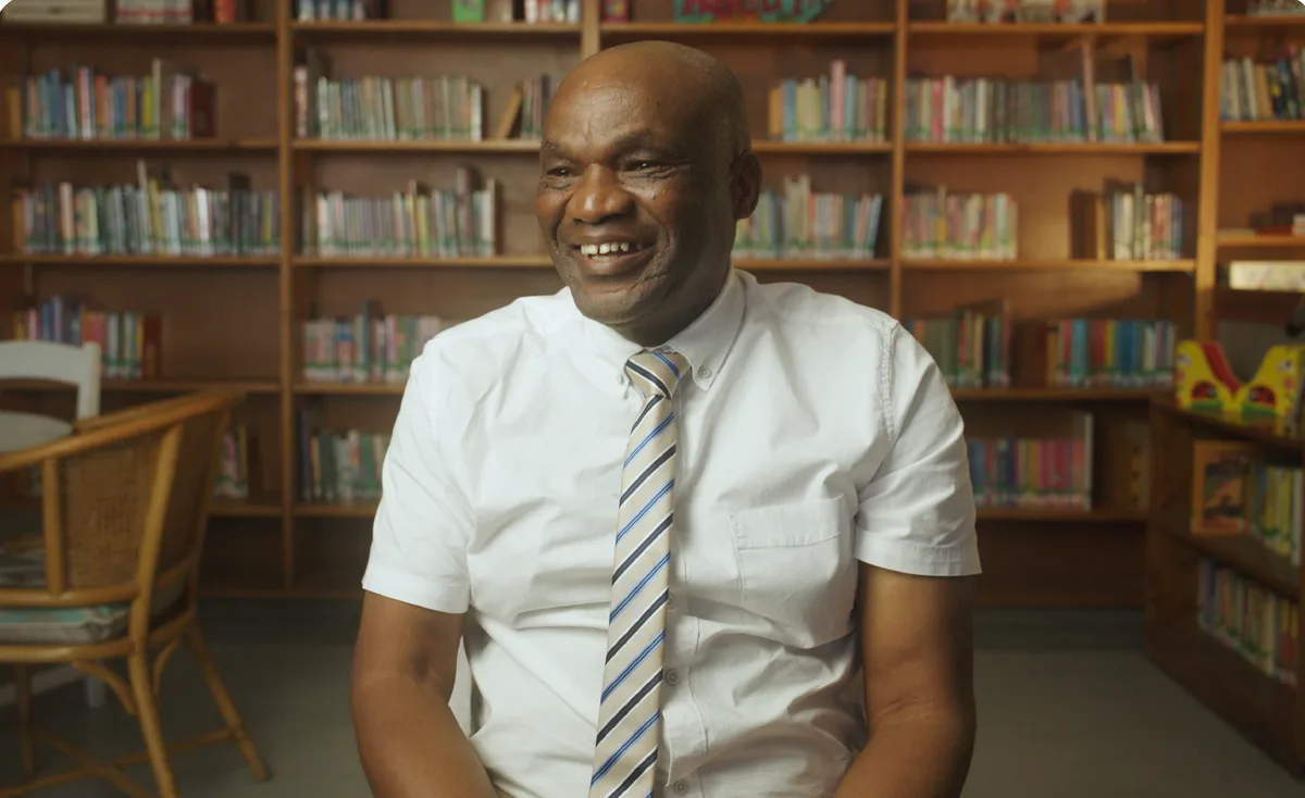 A headteacher interviewed in a school library